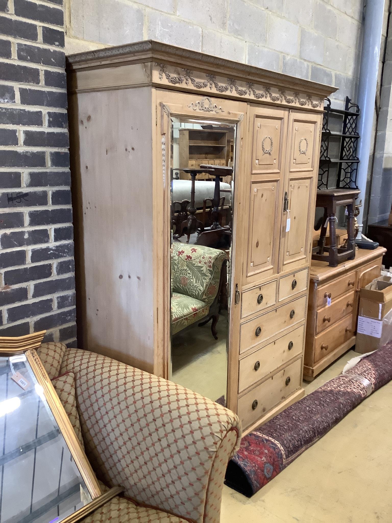 An Edwardian pine compactum wardrobe retailed by Maple & Co., length 113cm, depth 60cm, height 196cm